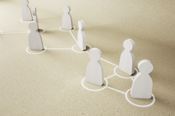 cooperation-collaboration-concept-with-white-wooden-figures-craft-paper-surface-with-drawn-circles